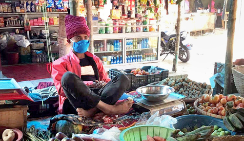 A shopkeeper in Bangladesh wearing a mask provided as part of the study. Photo: IPA-Bangladesh.